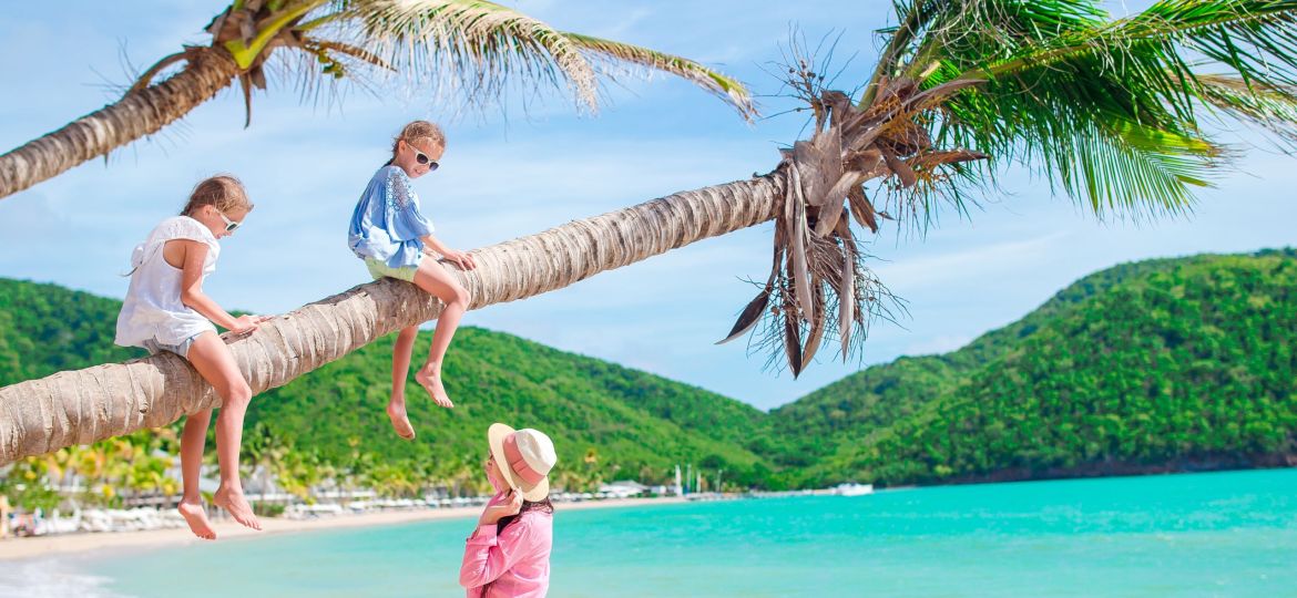 Young family on vacation have a lot of fun on palmtree